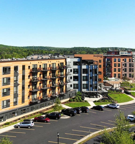 an aerial view of an apartment building and a parking lot