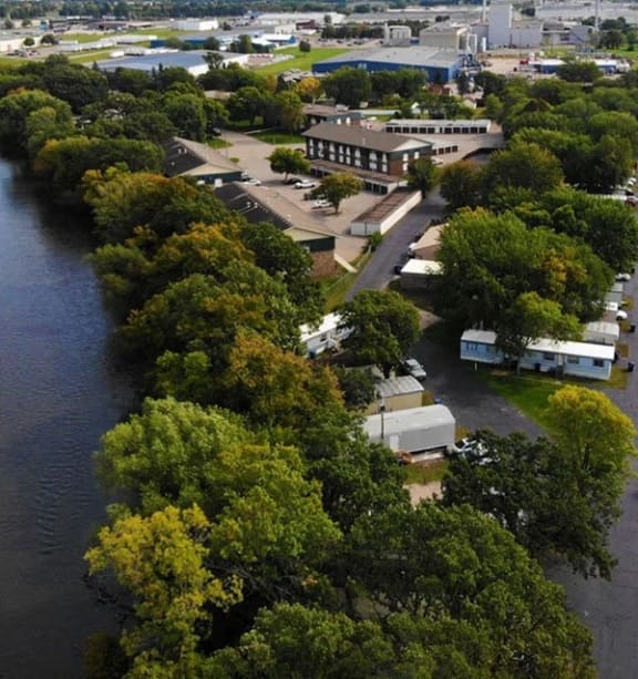 an aerial view of a large apartment building in a parking lot