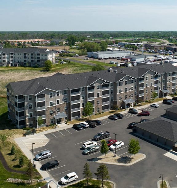 an aerial view of an apartment building in a parking lot