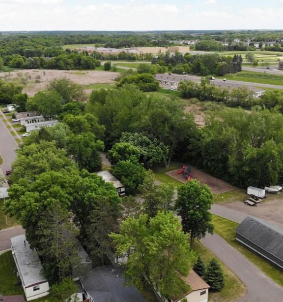an aerial view of an apartment building with a parking lot