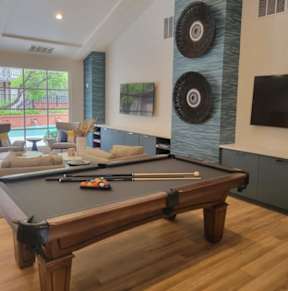A pool table with a billiard set on it.