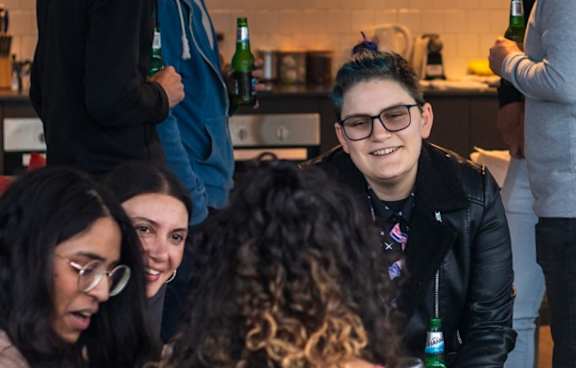 a living room with a green couch and a balcony