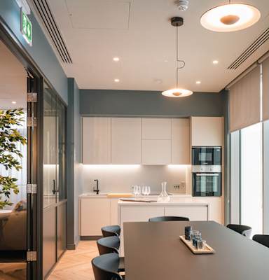 A modern kitchen with a dining table and chairs.