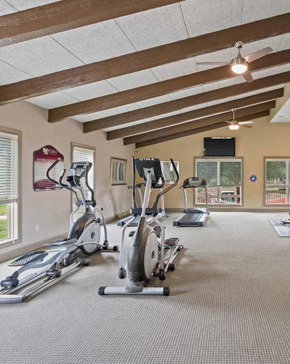 a gym with treadmills and other exercise equipment