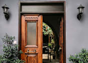 Thumbnail 112 of 112 - a wooden door with a glass window in front of a building