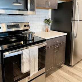 a kitchen with stainless steel appliances and a white counter top