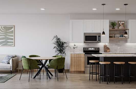 a living room and kitchen with white walls and wood flooring