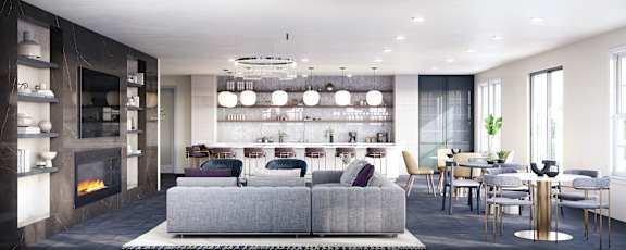 A modern living room with a grey sofa and a fireplace.