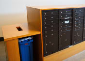 Thumbnail 12 of 23 - a lockers in a classroom with a blue trash can
