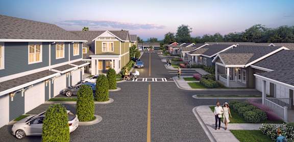 an aerial view of a street with rows of houses on each side
