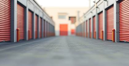 A long corridor with red doors on both sides.