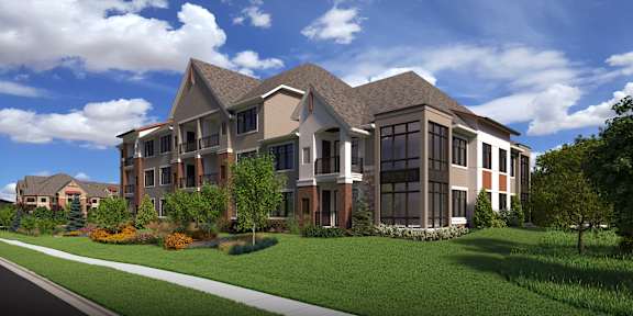 A large, modern house with a well-manicured lawn in front.