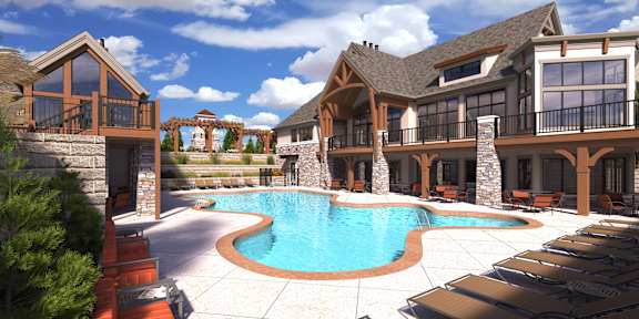 A large, luxurious house with a swimming pool in the backyard.
