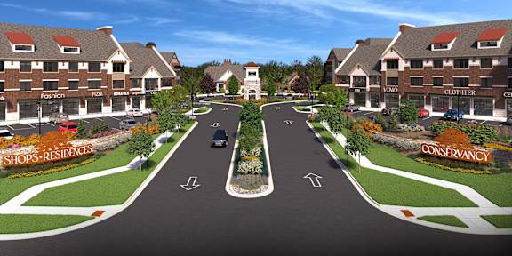 A street view of a shopping area with a sign for Conservancy.
