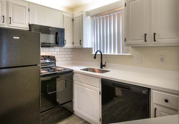 The kitchen in an upgraded 450 square foot efficiency apartment at Cambridge Court Apartments in Dallas, TX.
