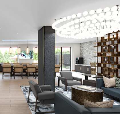 A modern living room with a large grey sofa and a wooden coffee table.