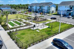 an aerial view of a park in the middle of a parking lot