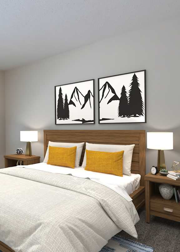 A bedroom with a bed, two lamps, and two framed pictures on the wall.