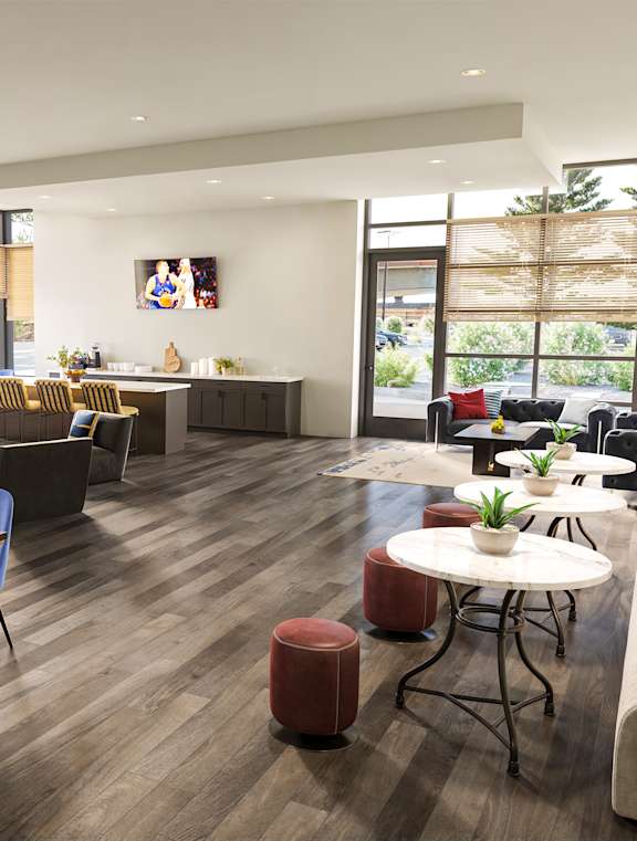 A modern living room with a dining area and a fireplace.