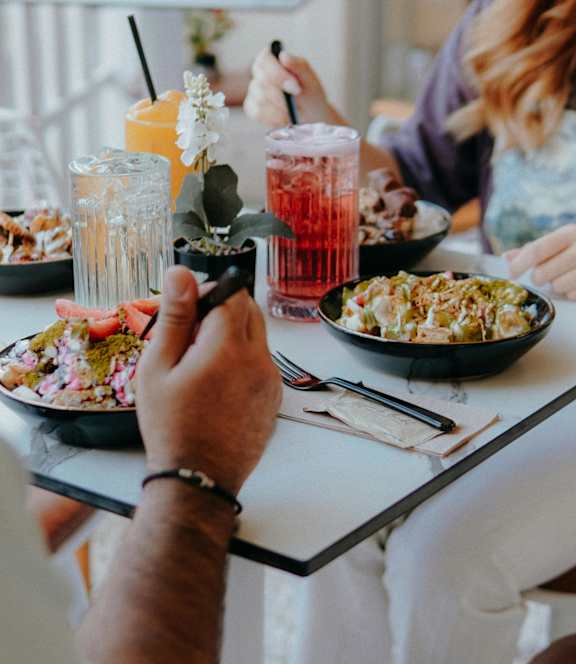A man and a woman are having a meal together.