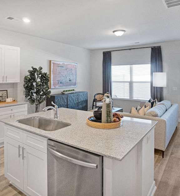 A modern kitchen with white cabinets and stainless steel appliances.