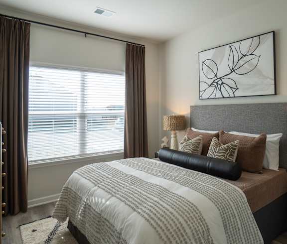 A bedroom with a large bed and a wooden headboard.