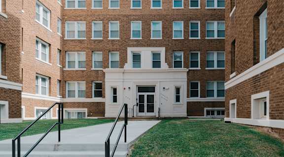 a large brick building with a white front door at Howard Manor, Washington, DC