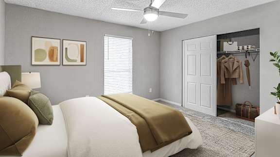 A bedroom with a white bed and a ceiling fan.