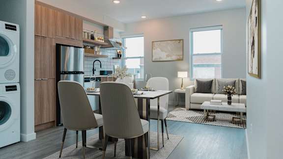 A modern kitchen with a dining table and chairs.