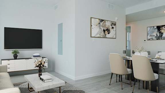 A modern living room with a flat screen TV, a coffee table, and a dining table with chairs.
