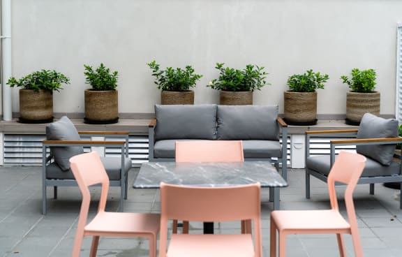 a living room with a green couch and a balcony