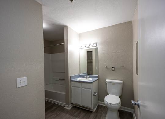 a bathroom with a toilet and a sink and a shower at Magnolia Pointe Apartments in Duluth, GA