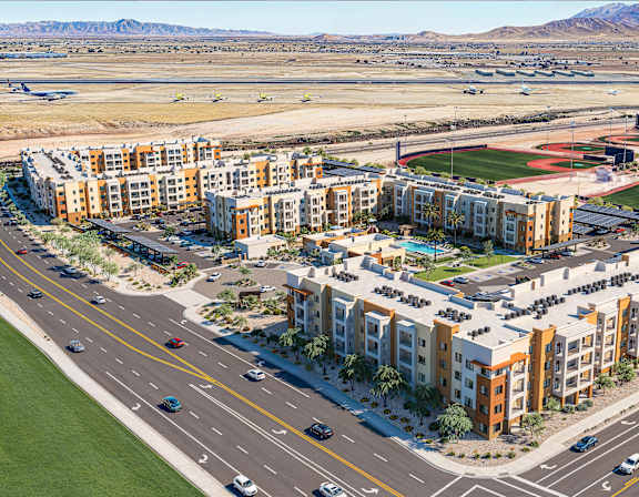 Aerial view of modern apartment complex near baseball fields at Vivir at Ballpark Village Apartments, Goodyear, Arizona