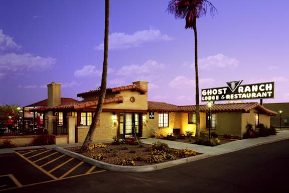 The Ghost Ranch Lodge & Restaurant is a building with a parking lot in front of it.