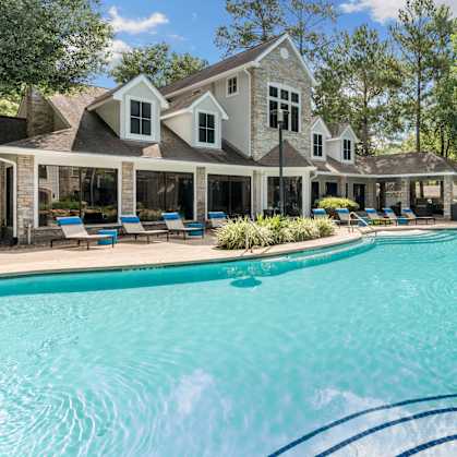 Alden landing pool with lounge chairs and outdoor grill 