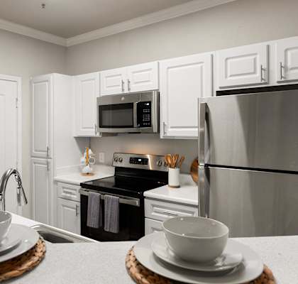 a kitchen with stainless steel appliances and white cabinets