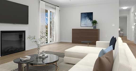 A modern living room with a white sofa and a black television.