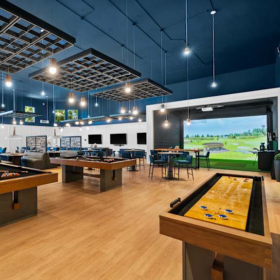 A room with a pool table and a billiard table.