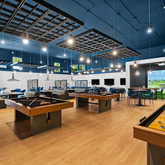 A room with a pool table and a billiard table.