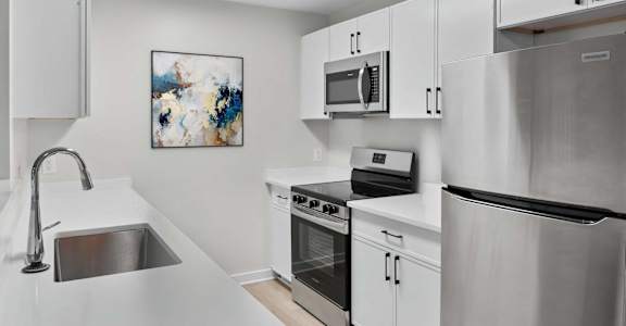 A modern kitchen with stainless steel appliances at Grand at Pearl Apartments, Pearl, 39208