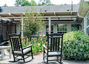 Thumbnail 7 of 7 - Two rocking chairs are on a patio.