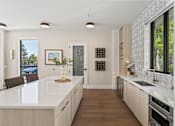 Thumbnail 3 of 28 - A modern kitchen with a white countertop and wooden cabinets. at Siena Villas Apartments, Orem, 84097