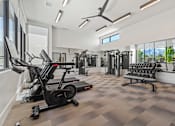 Thumbnail 8 of 28 - A spacious gym with a variety of equipment including treadmills, elliptical machines, and dumbbells. at Siena Villas Apartments, Orem, UT