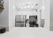 Thumbnail 7 of 26 - a kitchen with stainless steel appliances and white cabinets