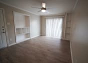 Thumbnail 2 of 11 - an empty living room with a closet and a ceiling fan