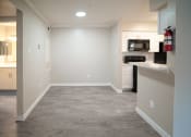Thumbnail 5 of 11 - a renovated kitchen with a hard wood floor and white cabinets
