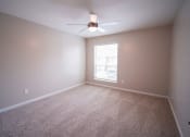 Thumbnail 10 of 11 - an empty room with carpet and a ceiling fan