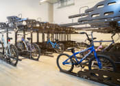 Thumbnail 1 of 23 - a rack of bikes in a room with other bikes on racks