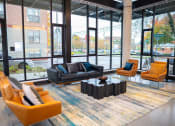 Thumbnail 8 of 23 - a lobby with couches and chairs and a coffee table