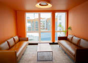 Thumbnail 14 of 23 - a living room with leather couches and a coffee table